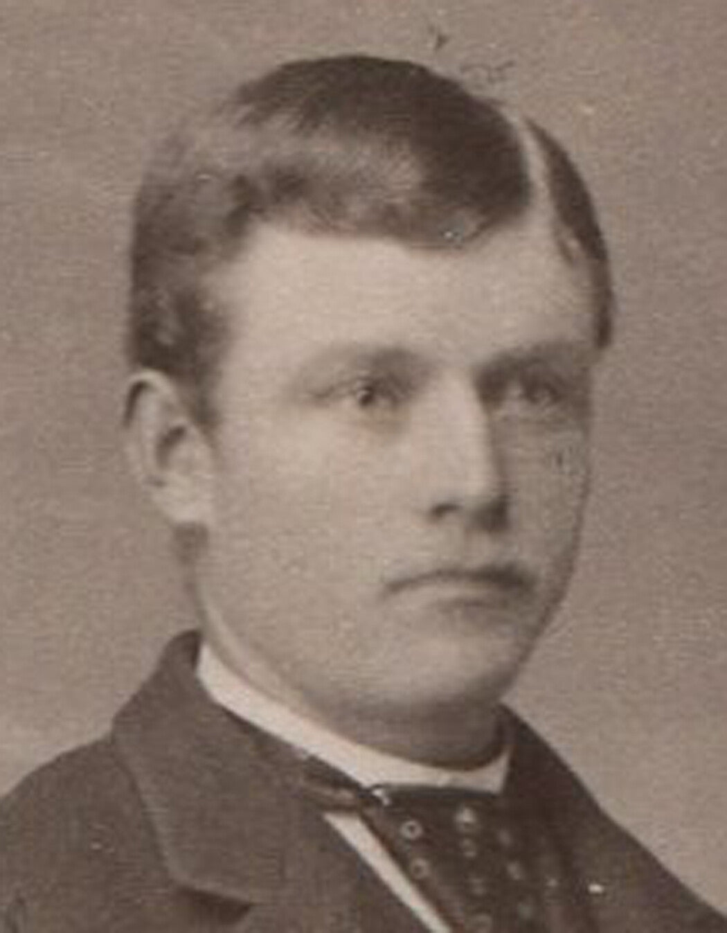 UNCOMFORTABLE LOOKING YOUNG MAN, CABINET CARD. AKRON, OHIO.