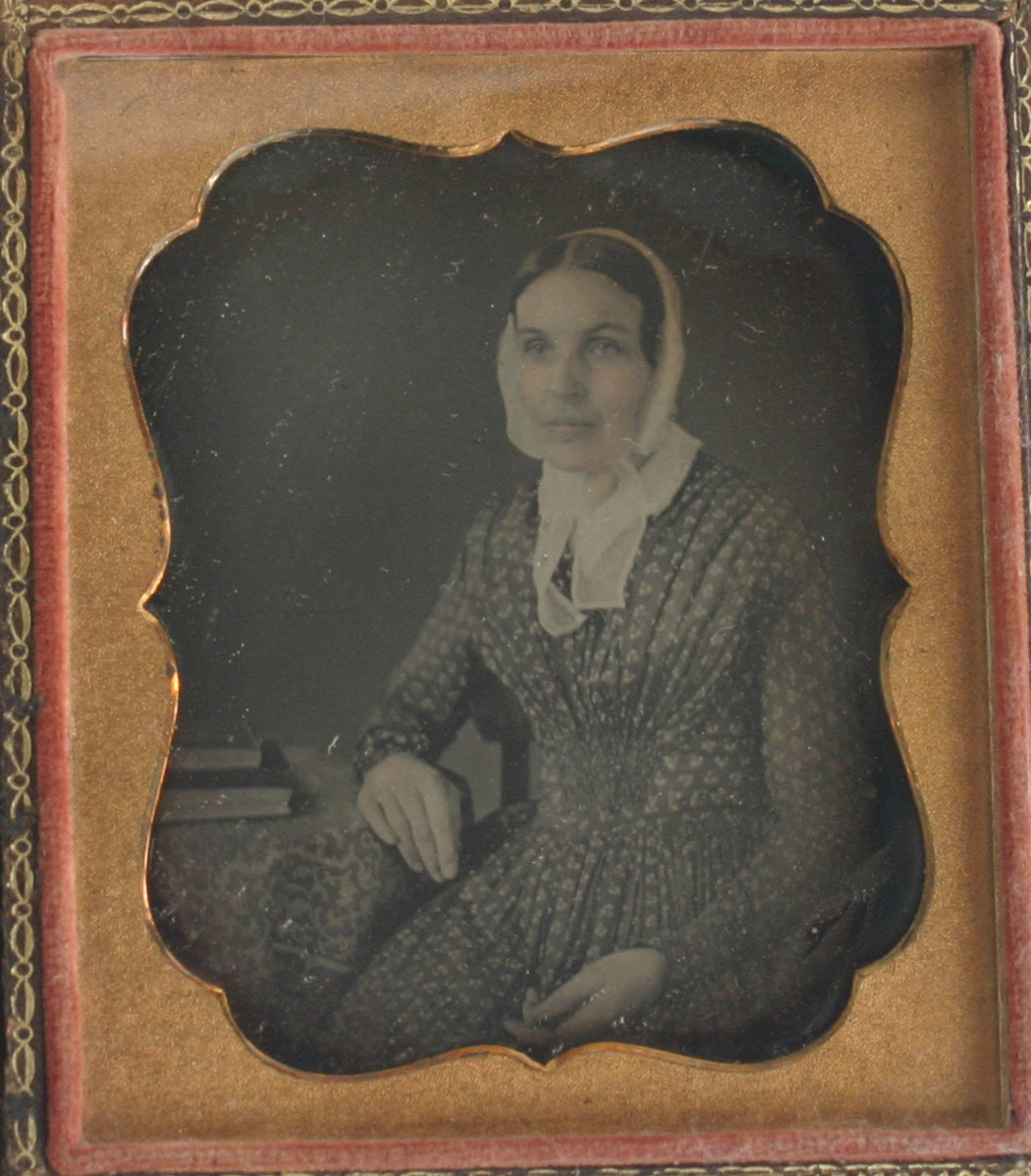 WOMAN IN BONNET, PRINT DRESS. TINTED DAGUERREOTYPE 6TH PLATE, FULL CASE.