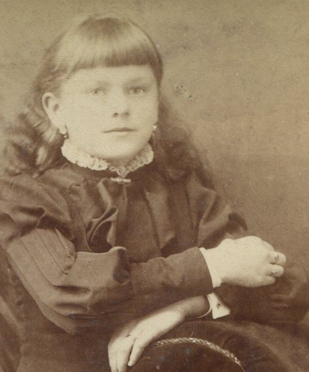 YOUNG GIRL LEANING ON CHAIR. CABINET CARD. OSHKOSH, WIS.
