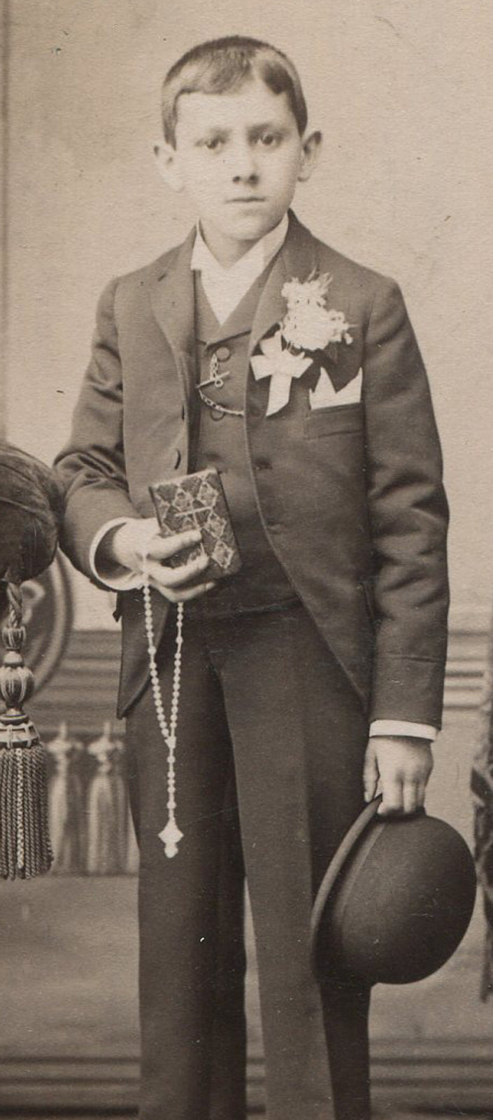 YOUNG BOY IN COMMUNION OUTFIT, HOLDING PRAYER BOOK, ROSARY, BOWLER HAT.