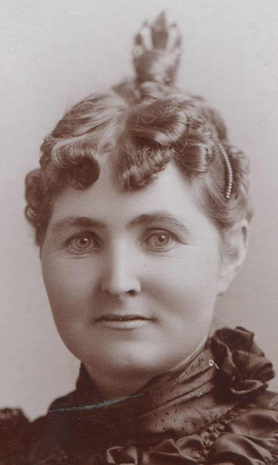 Vintage cabinet card photo: Softly featured woman in pleated embellished dress, chic updo, Chicago portrait