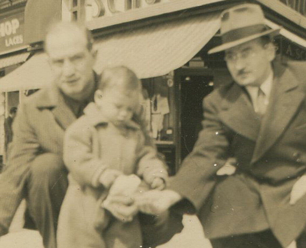 Vintage 1940s black-and-white photo: man helping toddler feed a pigeon - retro wall art