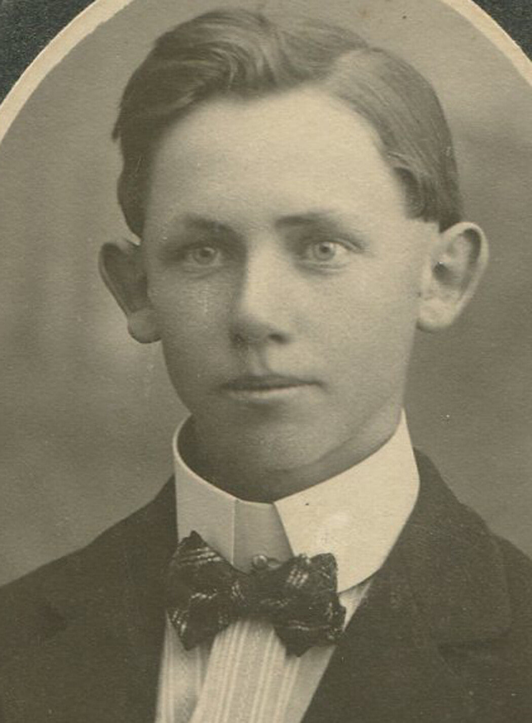 Vintage photo: Big-eared young man with bow tie, original 1890s portrait, oval 2.5x2, card 5x3.5
