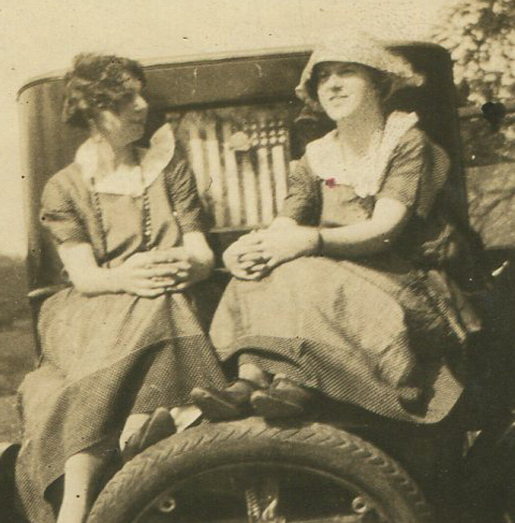 Vintage Model T Ford black-and-white photo with two women and U.S. flag in rear window - circa 1910 wall art