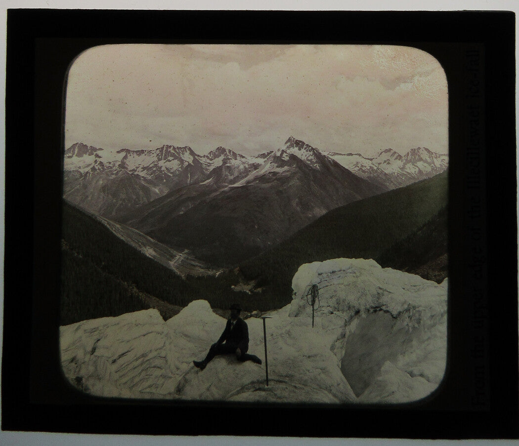 MAN SITTING ATOP ILLECILLEWAET GLACIER. PHOTO ON GLASS.