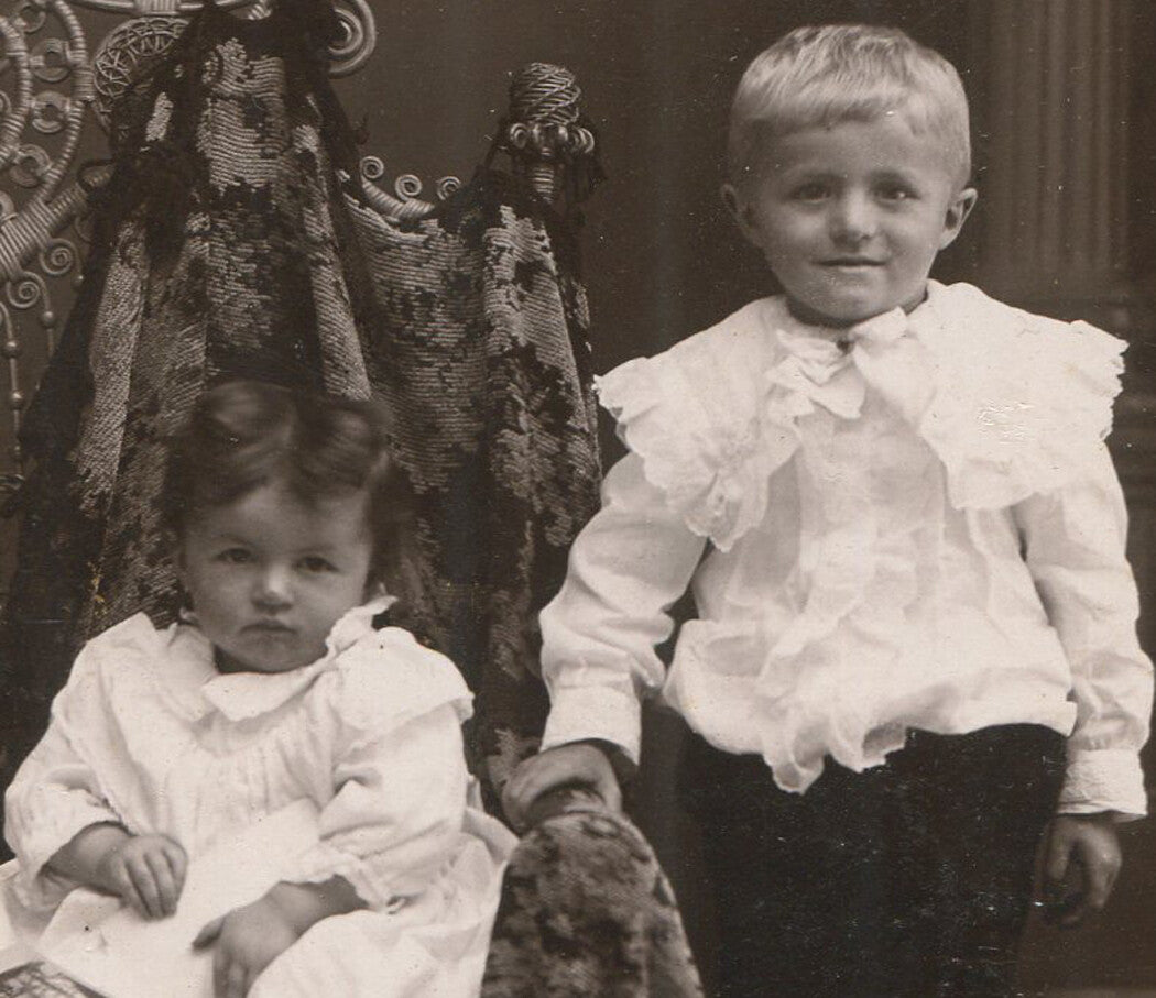 YOUNG SIBLINGS, ONE SEATED WITH PHOTOS. THEY LOOK LIKE TROUBLE. CABINET CARD.