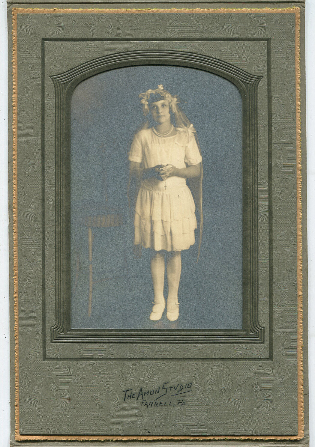 GIRL IN COMMUNION, CONFIRMATION ATTIRE. SILVER PRINT IN FOLDER. FARRELL, PA.