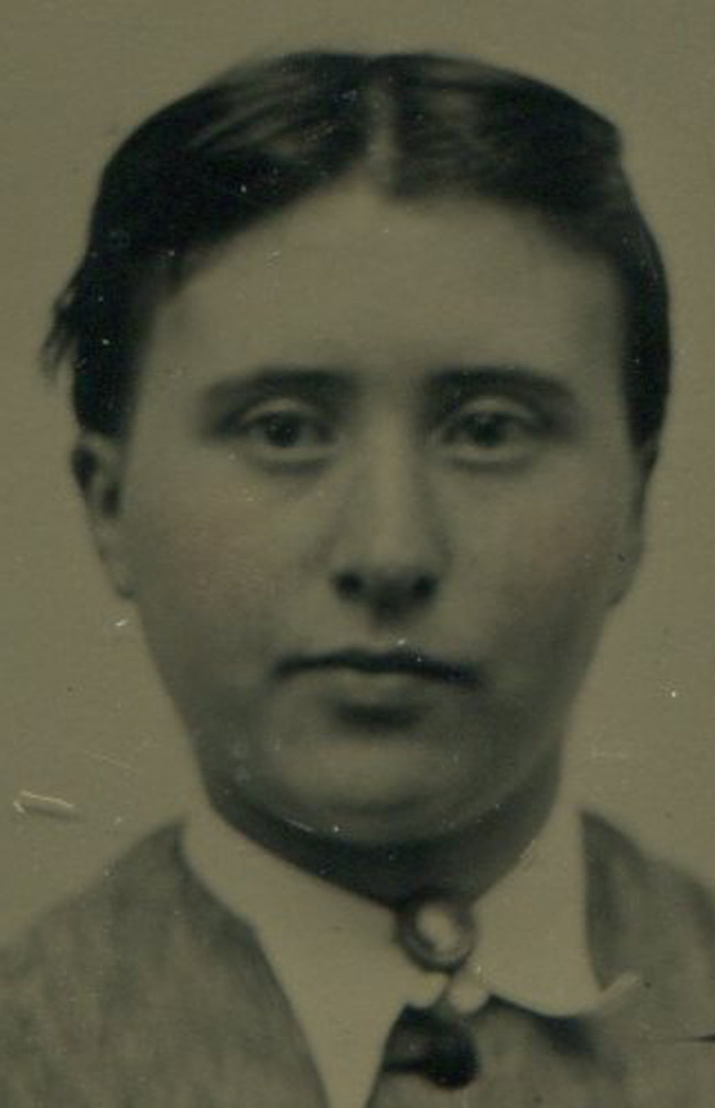 WOMAN, DARK PULLED BACK HAIR. TINTED TINTYPE.