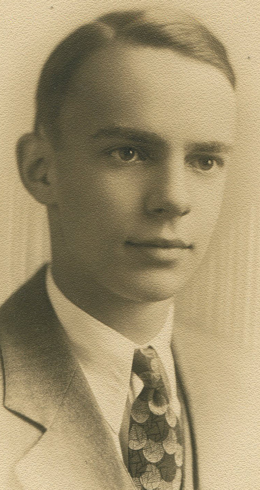 WHOLESOME LOOKING YOUNG MAN WEARING VERY COOL TIE. TONED SILVER PRINT, 1950s.