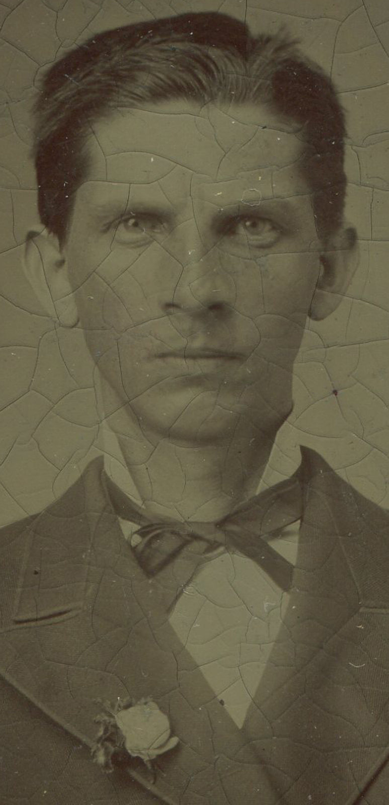 SCARY DUDE, THIN MAN W/LAPEL ROSE. TINTYPE IN PERIOD PAPER MAT.
