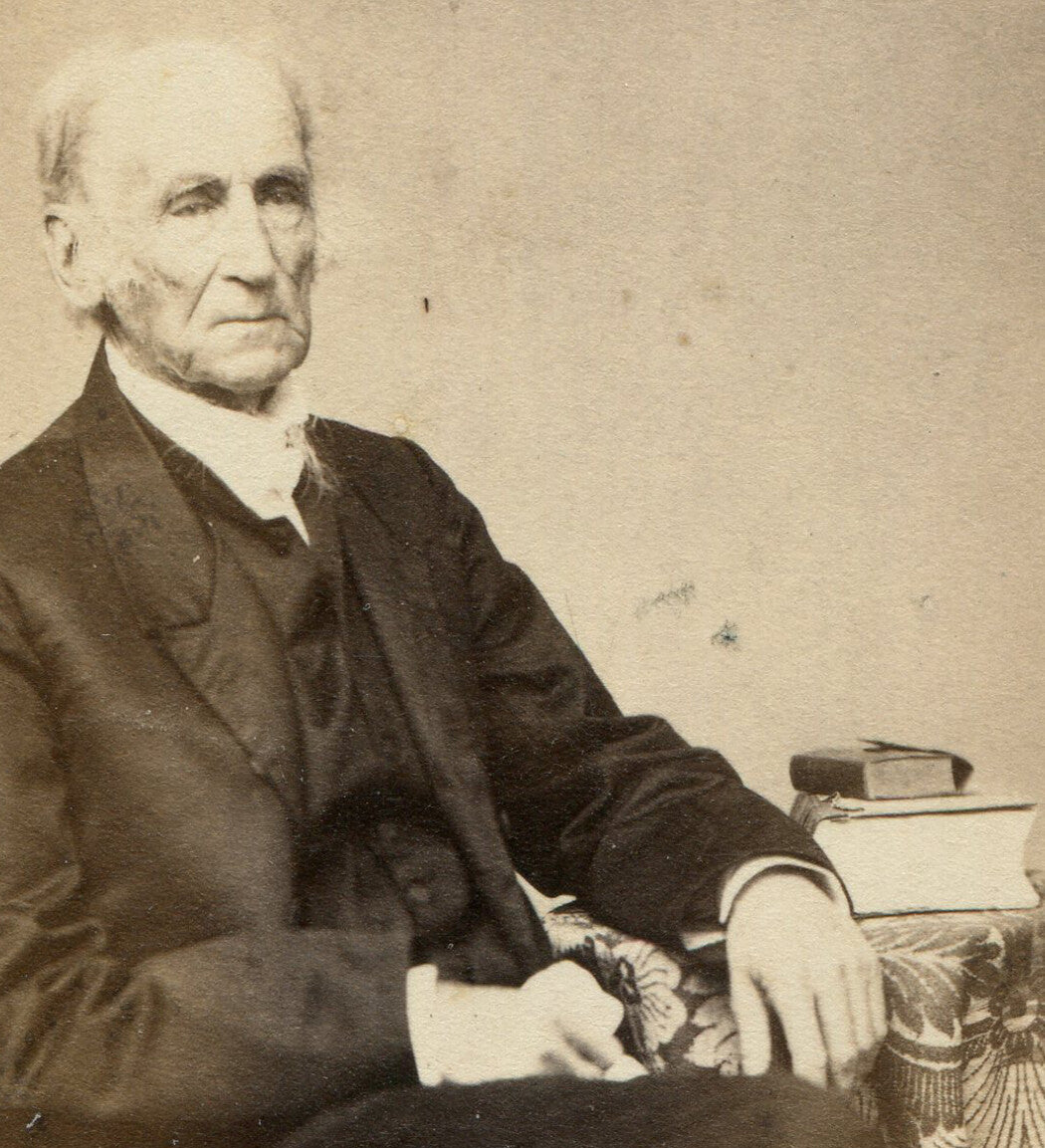 OLD MAN POSED SEATED AT TABLE WITH BOOKS. CDV. PAWTUCKET, R.I.