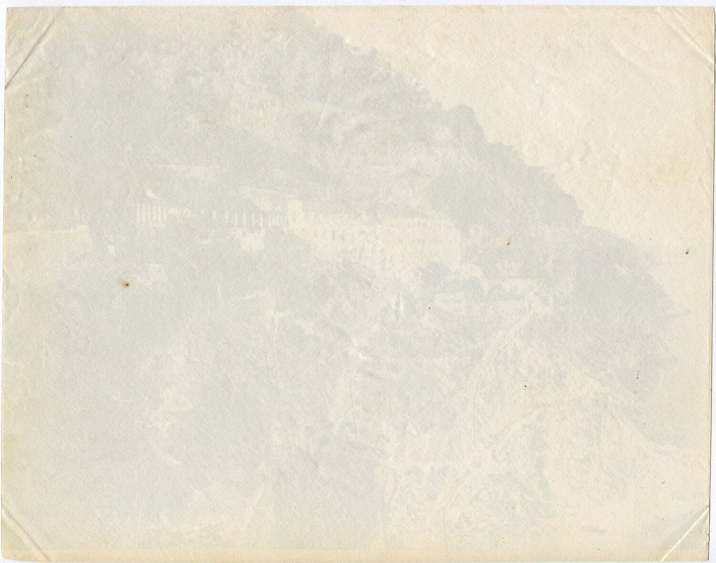 VILLAGE CLINGS TO CLIFFS ABOVE SEA. STAIRS CLIMB THE HILLSIDES TO A VILLAGE.