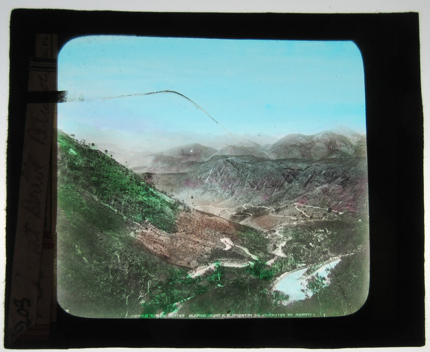 BEAUTIFUL VIEW OF WINDING MOUNTAIN ROAD. HAND COLORED PHOTO ON GLASS.