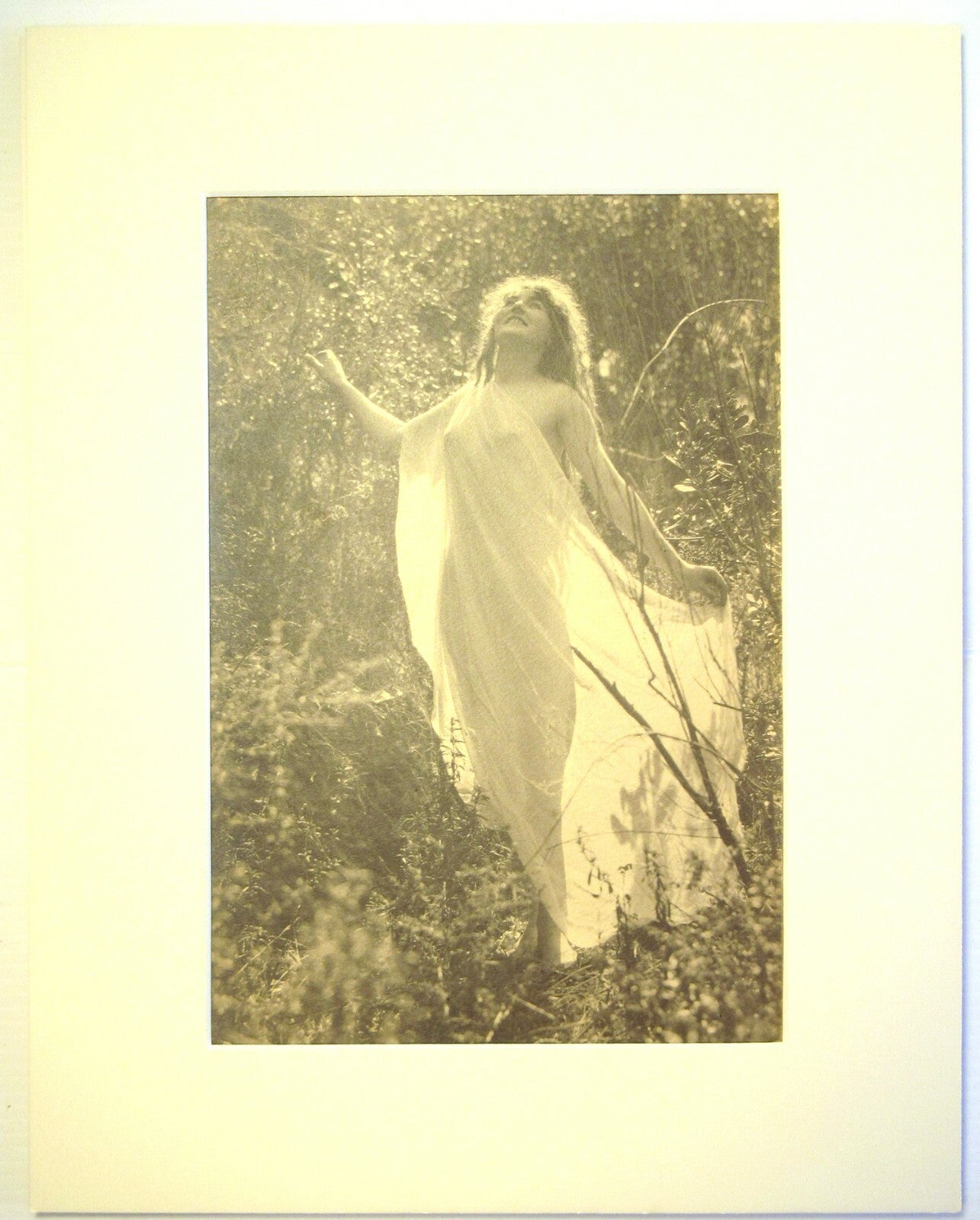 SEMI NUDE WOMAN IN NATURE. 10X7 B&W IN 11X14 INCH ARCHIVAL MAT.