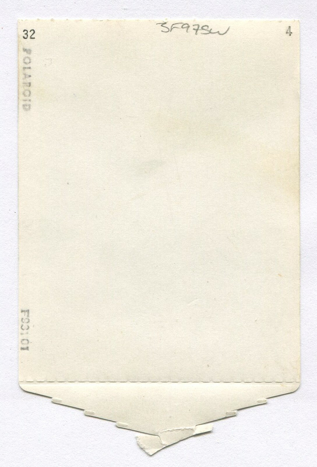 YOUNG AFRICAN AMERICAN BOY, RELAXED POSE. POLAROID PHOTO, 1950s