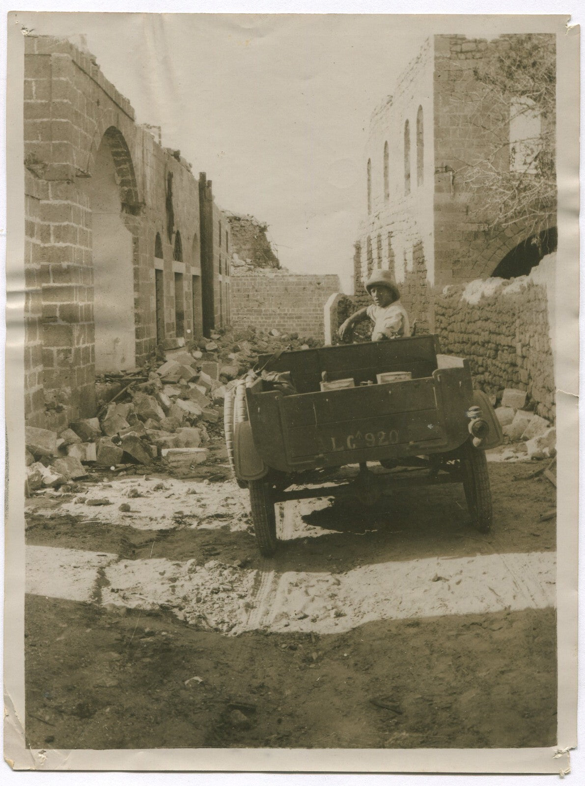 BRITISH SOLDIER DRIVES THROUGH THE RUINS IN GAZA. WWI. (8X10 REPRINT)