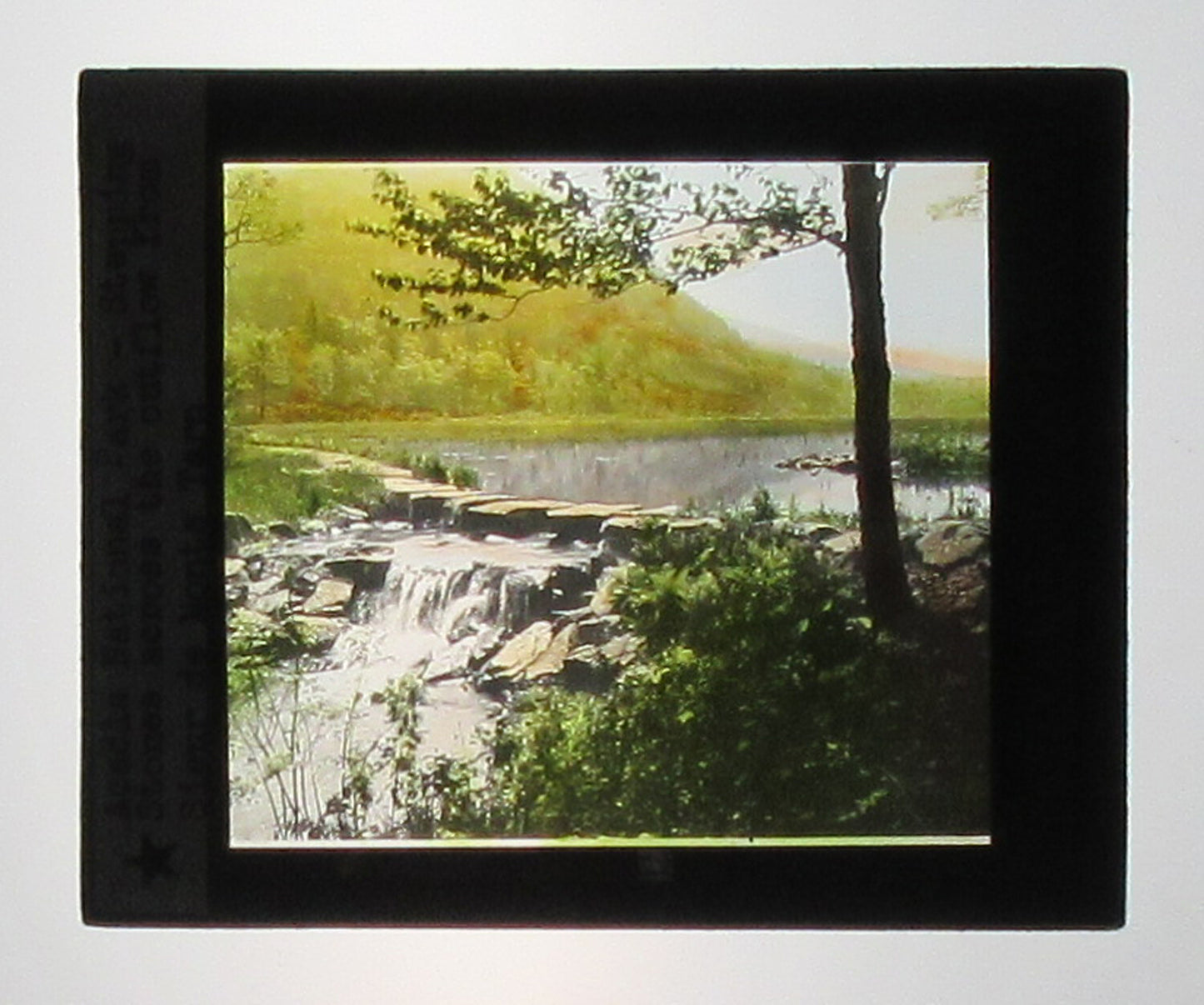 ACADIA NATIONAL PARK, STEPPING STONES. HAND COLORED PHOTO ON GLASS.