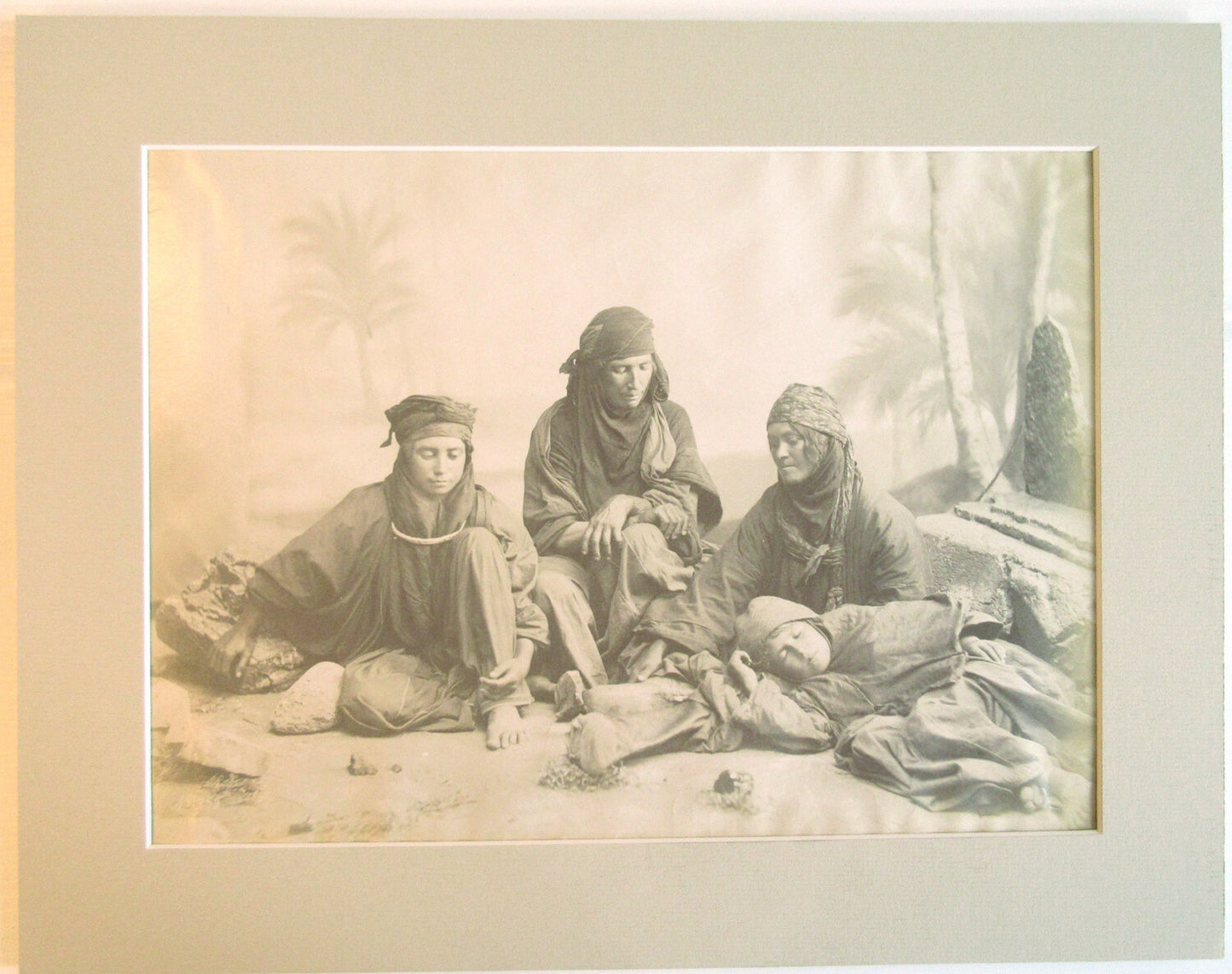 BEDOUINE FAMILY IN RELAXED POSE. ALBUMEN PHOTO IN 11X14 ARCHIVAL MAT.