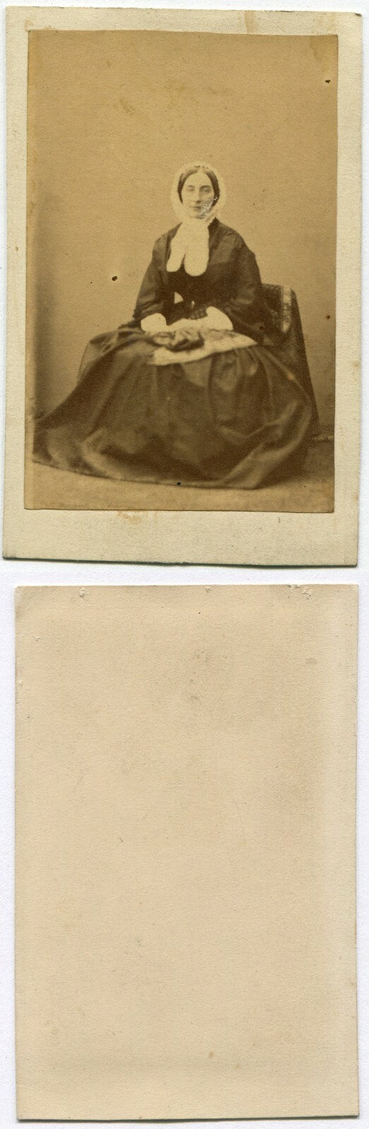WOMAN IN BONNET WITH LONG BOW, FABRIC ON LAP. CDV.