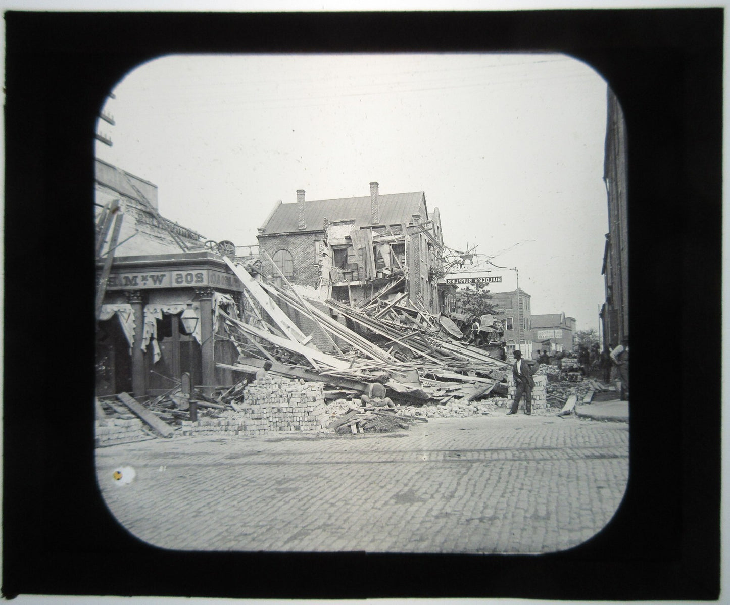 BUILDING COLLAPSE AFTERMATH. LANTERN SLIDE.