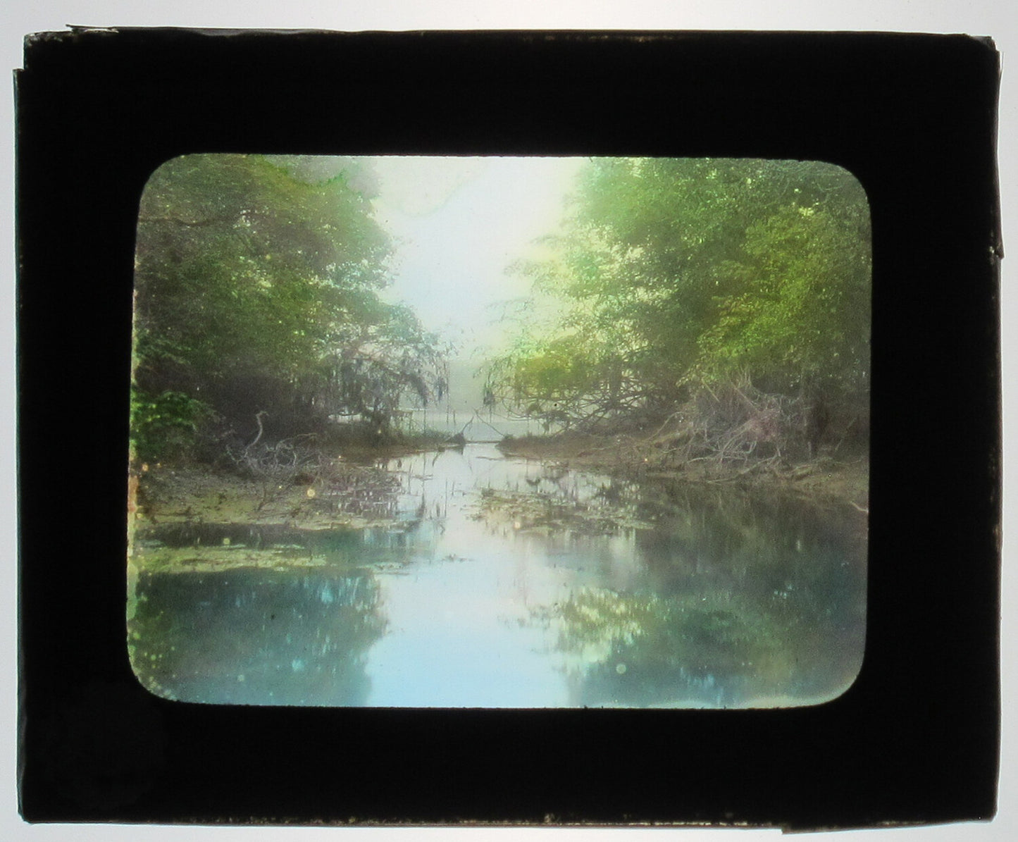 THE RIVER'S EDGE, TAPERINHA, AMAZON, BRAZIL.TINTED PHOTO ON GLASS.