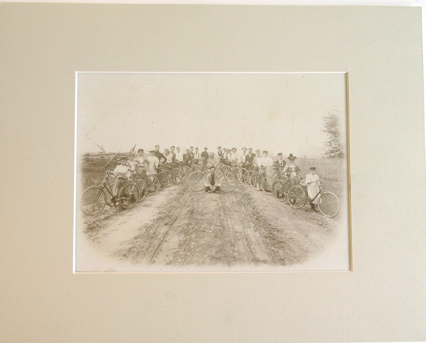 BICYCLISTS POSE ALONG DIRT ROAD. 7.5X10 INCH TONED SILVER PRINT IN 11X14 MAT.