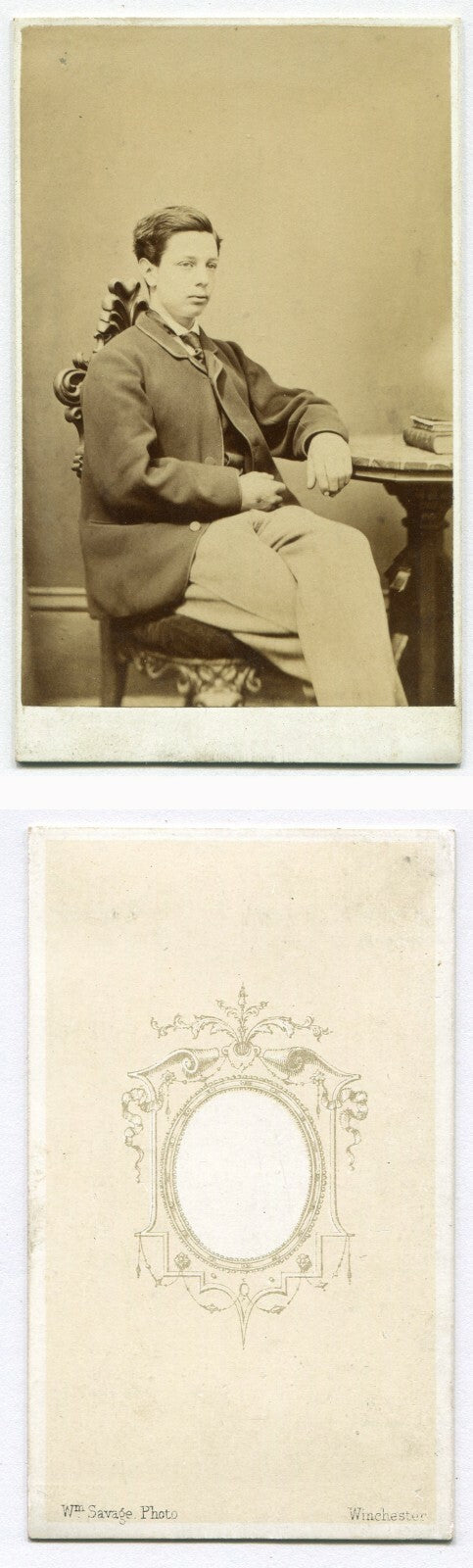 VERY YOUNG MAN SEATED AT TABLE W/BOOKS. CDV. WINCHESTER, ENGLAND.