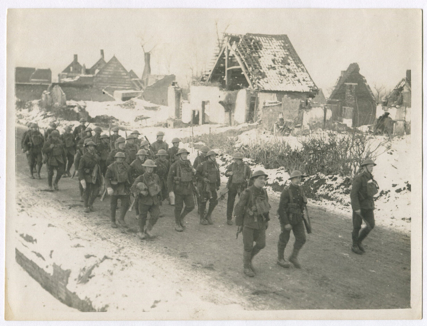 BRITISH EAST LANCASHIRES MARCH THROUGH RUINED VILLAGE. WWI. (8X10 REPRINT)
