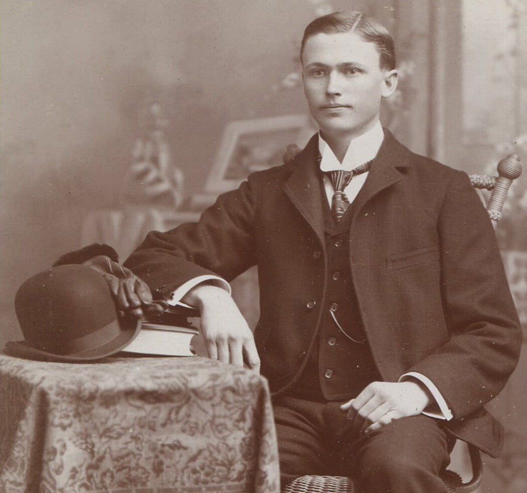 Vintage cabinet card photo: young man at table with books, gloves, bowler hat –