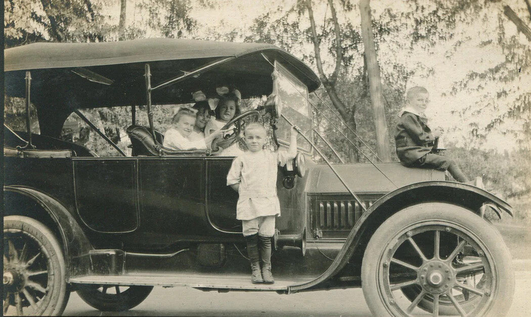 Vintage family photos 4-shot black and white set with kids on an early-model car
