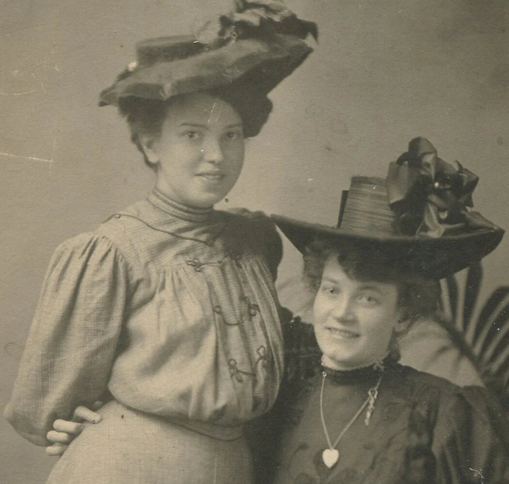 Vintage Black & White Photo: Two Women in Affectionate Pose, Mary Poppins Hats,