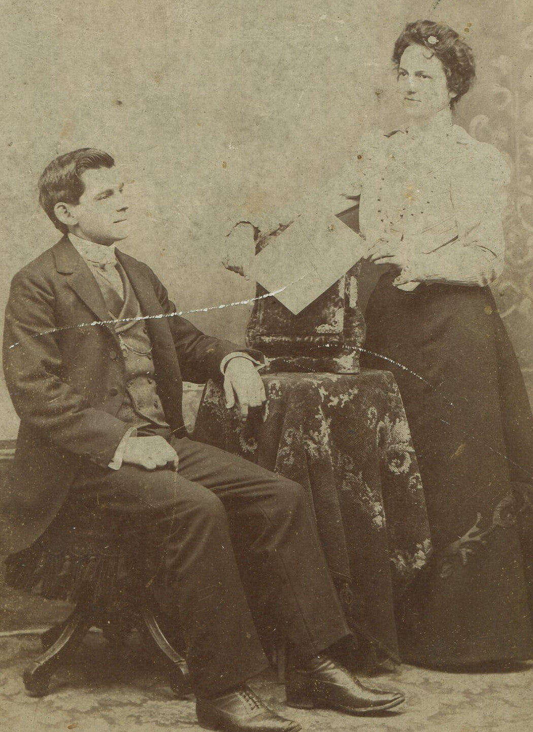 COUPLE, WIFE SERVING HUSBAND WITH DIVORCE PAPERS. CABINET CARD.