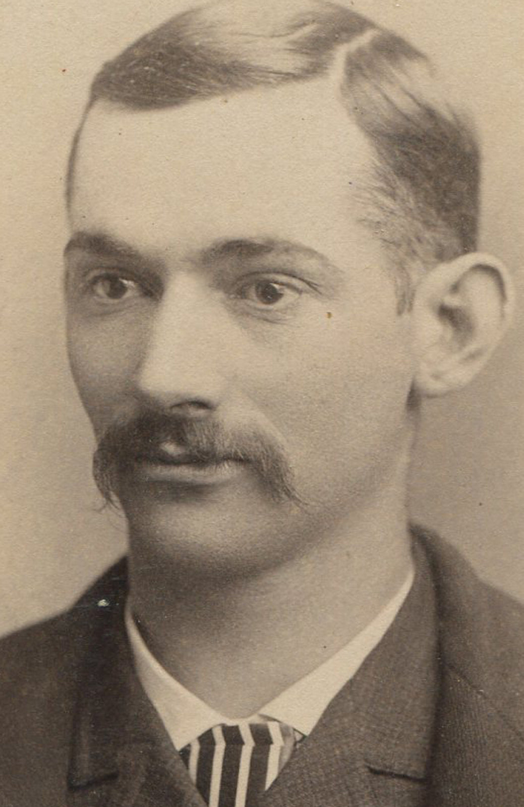 MAN WITH SCRAGGLY MUSTACHE, STRIPED TIE. CABINET CARD. BURLINGTON, IOWA.