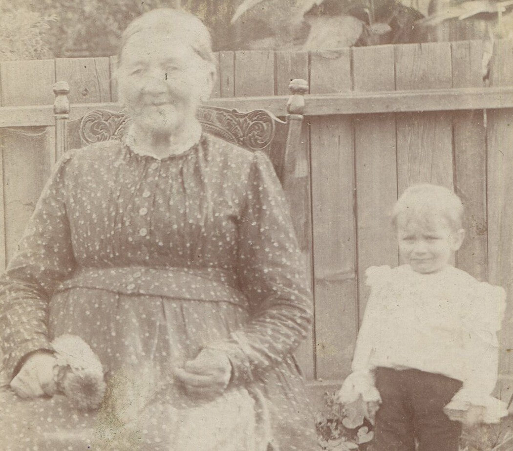 Vintage cabinet card photo: Grandma in the garden, photobombed by grandson -