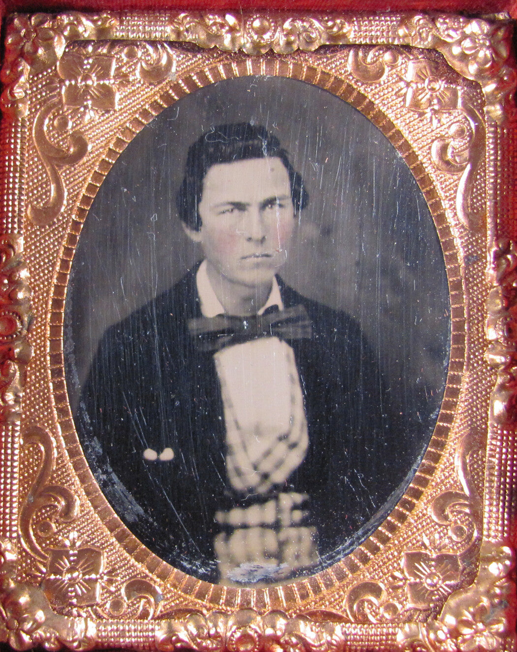 MAN IN PLAID VEST, BIG BOW TIE. TINTED 9TH PLATE TINTYPE, FULL CASE.