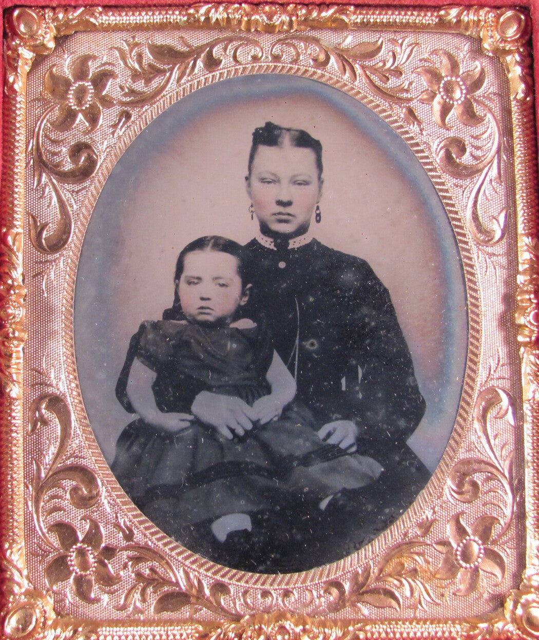Vintage 6th-plate tinted tintype portrait photo: daughter on mother's lap in