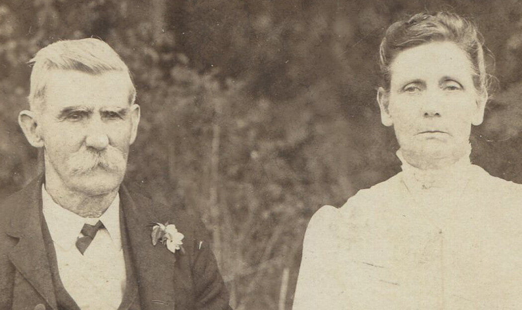 GRUMPY GRANDPARENTS WAITING IN GARDEN FOR DINNER. OVAL PHOTO, 5 X 3.75 INCHES.
