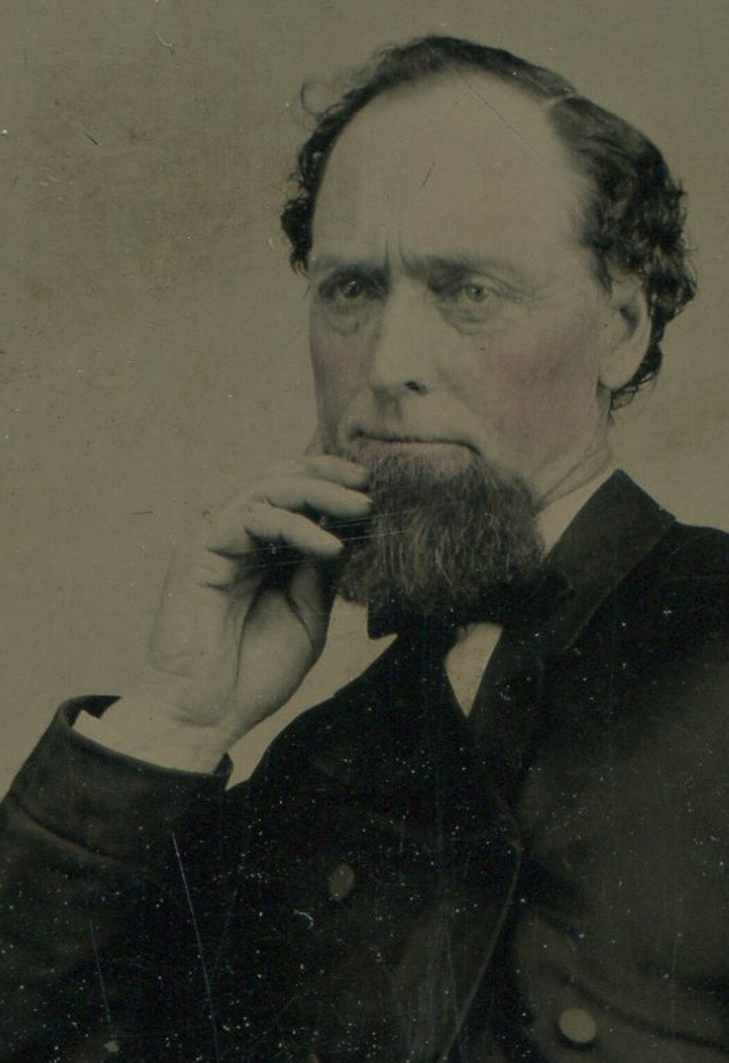Vintage hand-tinted tintype portrait photo -- bearded man deep in thought,