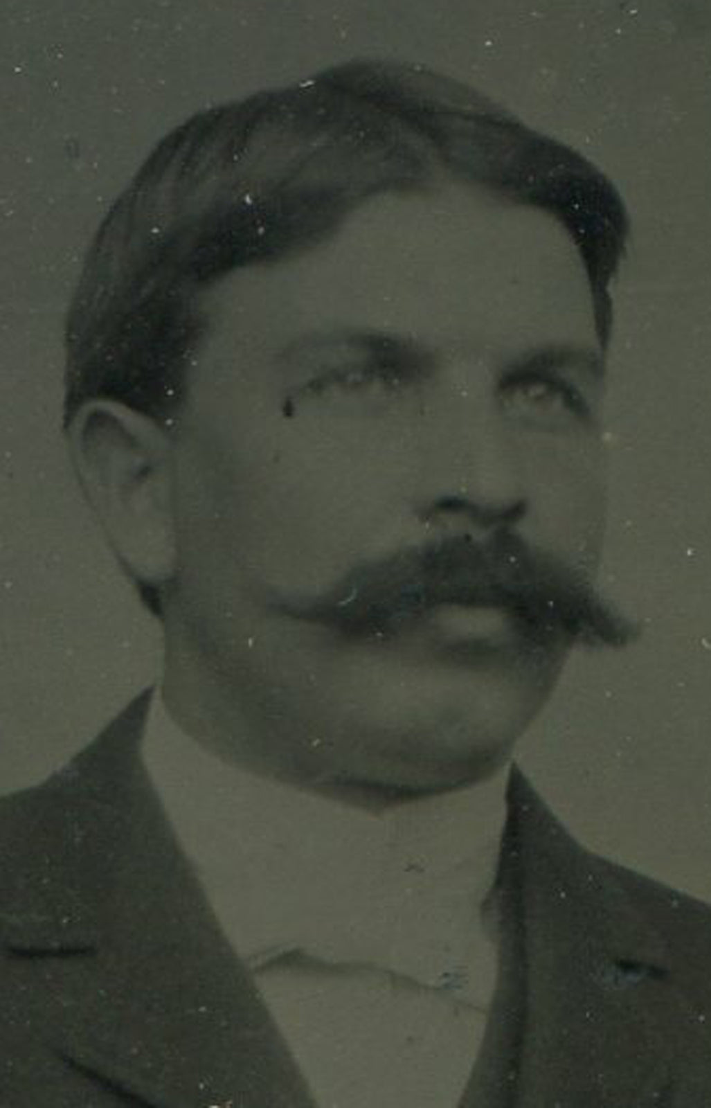 MAN W/ BIG MUSTACHE, SEATED POSE. TINTYPE IN PERIOD PAPER MAT.