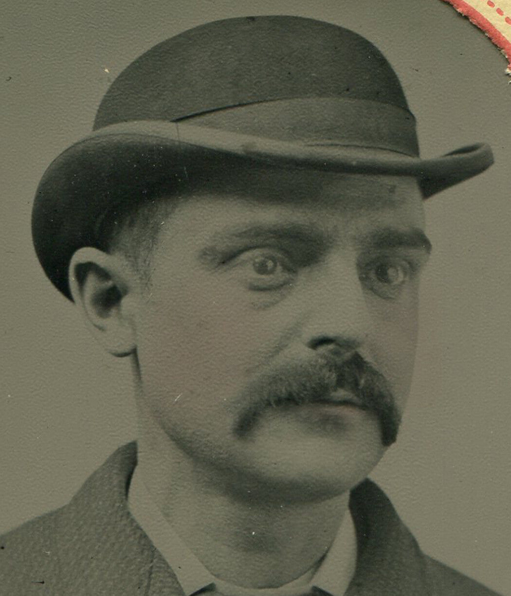 MAN W/ MUSTACHE, BOWLER HAT CONCEALING ROBOT BRAIN. TINTED TINTYPE, PAPER MAT.