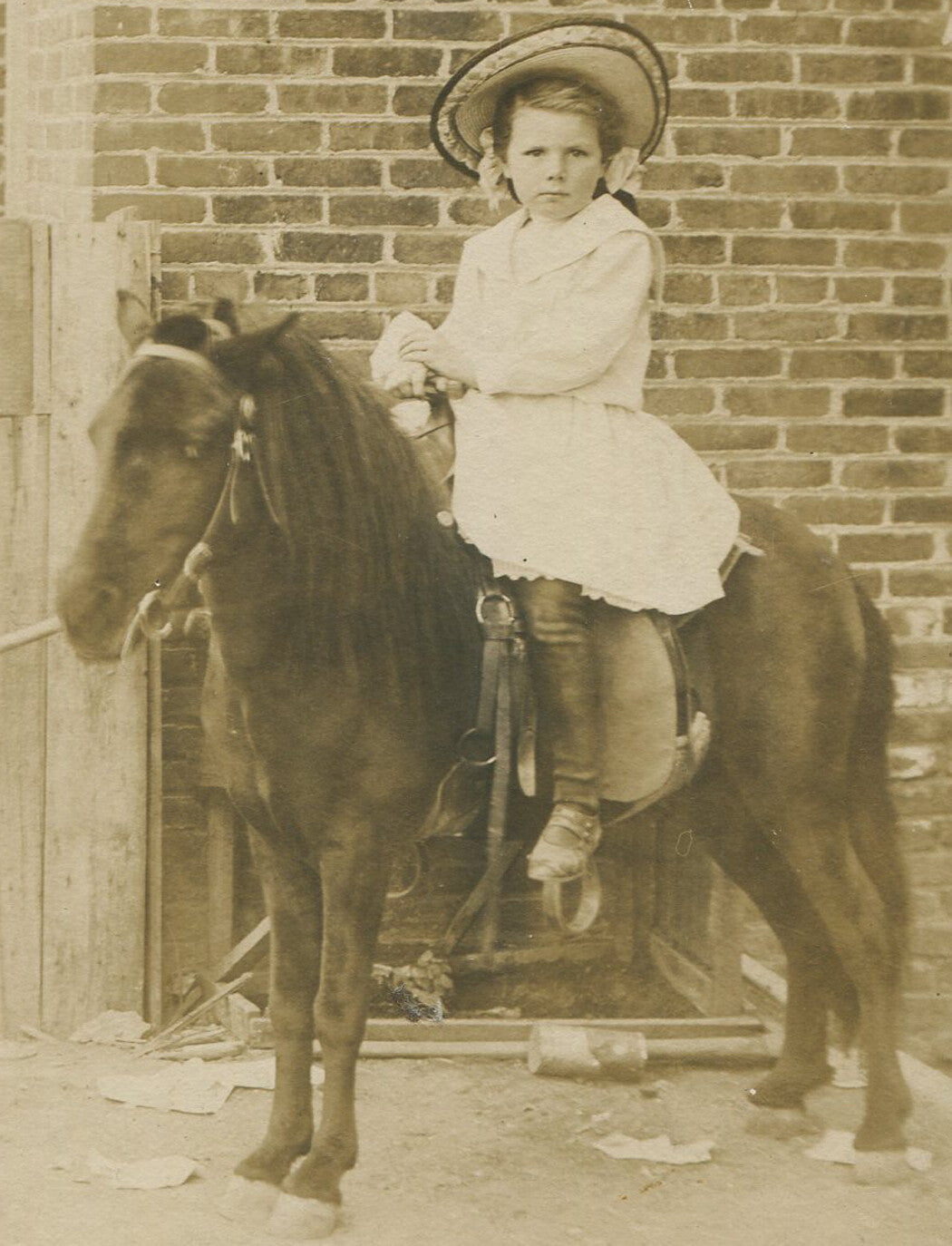 LITTLE GIRL IN HAT ON A PONY. CABINET CARD.