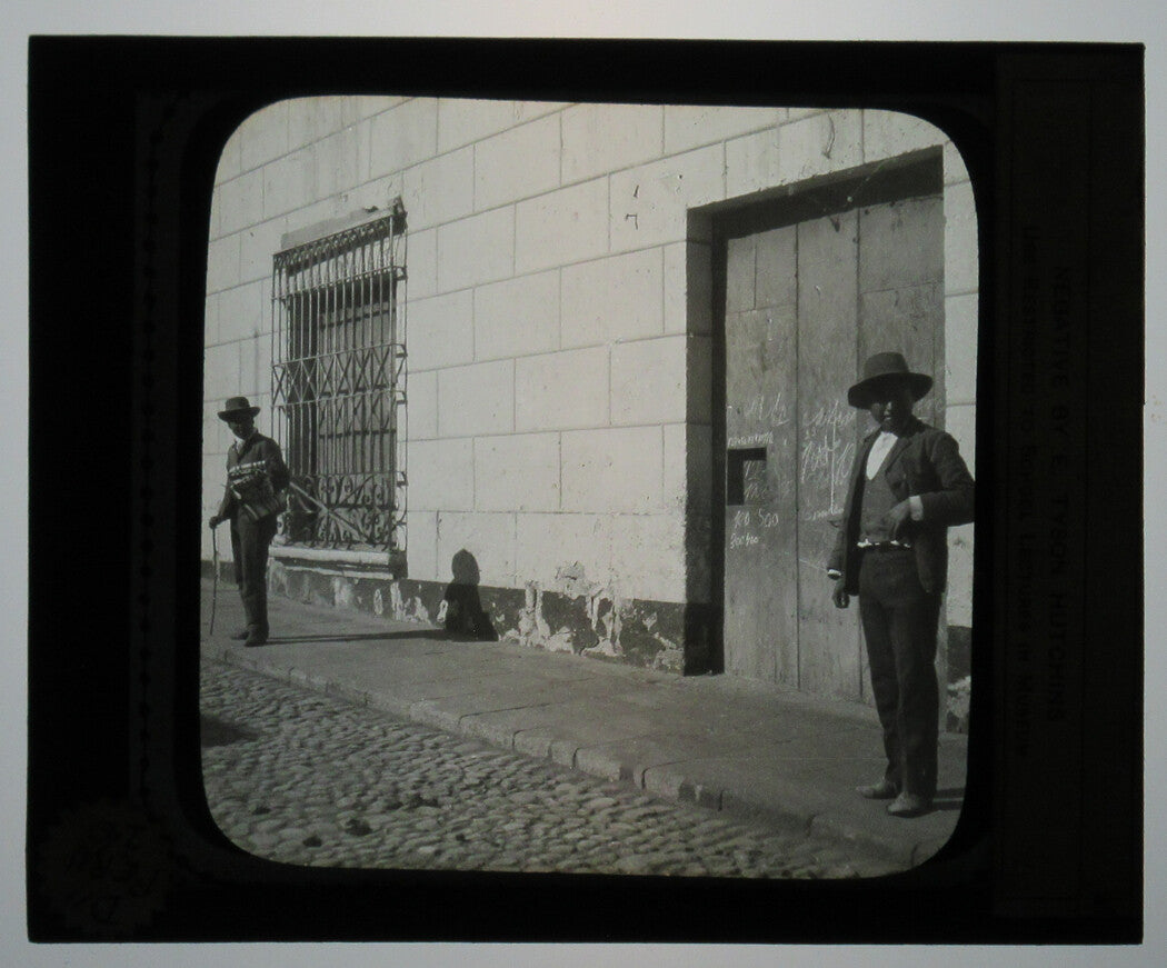 MEN OUTSIDE HOTEL ENTRANCE. AREQUIPA, PERU. PHOTO ON GLASS.