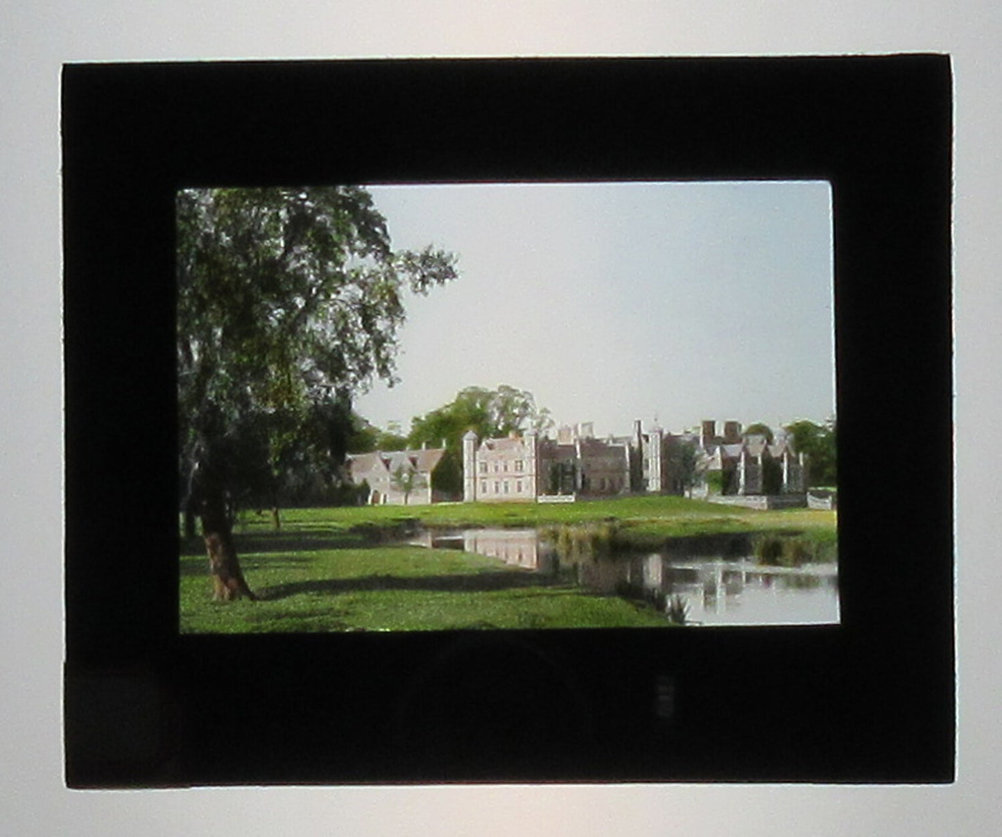 EUROPEAN ESTATE HOUSE AND GROUNDS. HAND COLORED PHOTO ON GLASS.