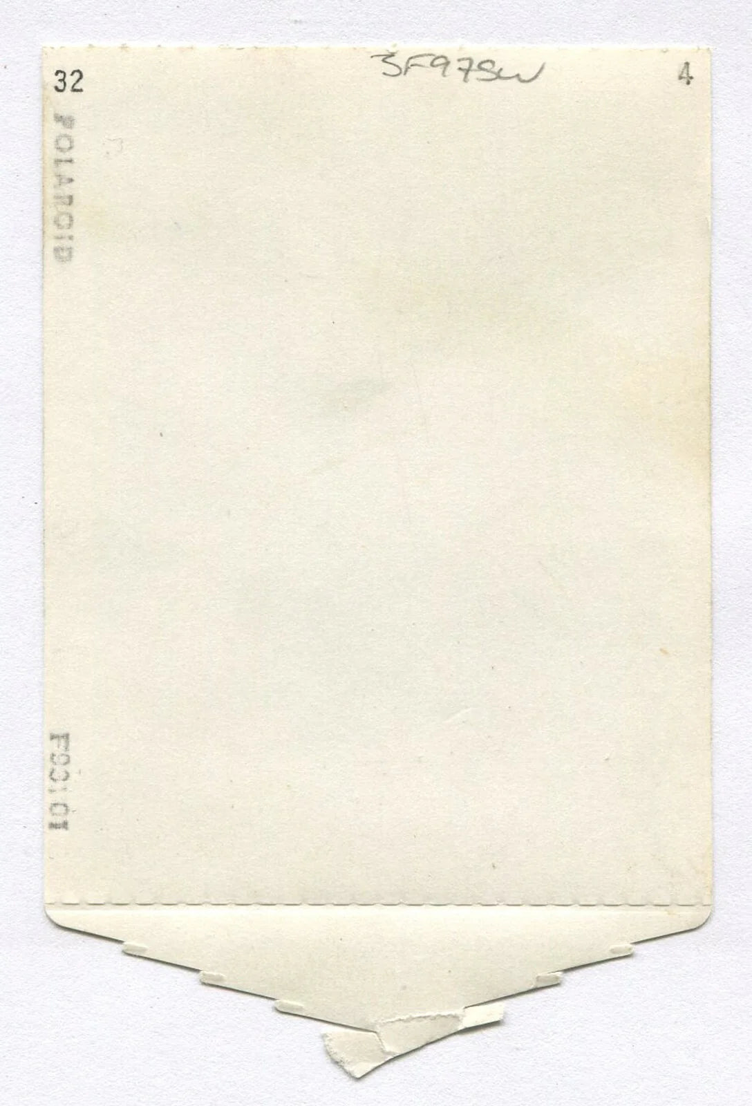 YOUNG AFRICAN AMERICAN BOY, RELAXED POSE. POLAROID PHOTO, 1950s