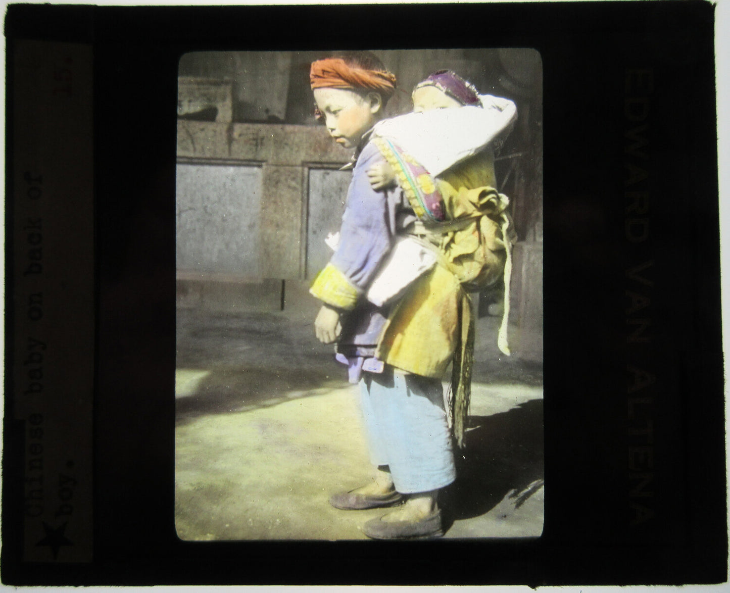 CHINESE BOY CARRYING YOUNG SIBLING ON BACK. TINTED LANTERN SLIDE.