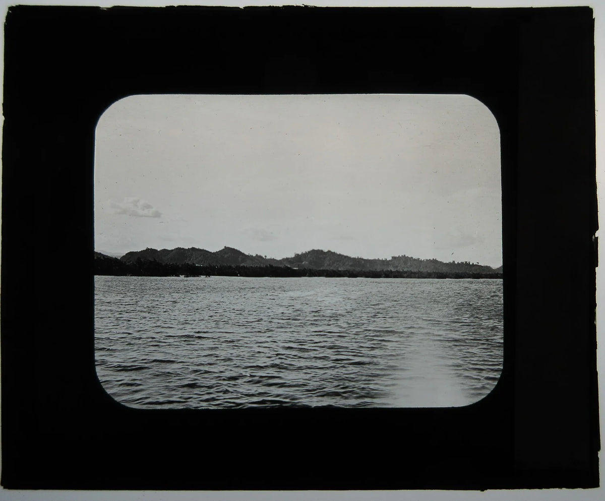 SCENE ON WATER, MOUNTAINS AT DISTANCE. PHOTO ON GLASS.
