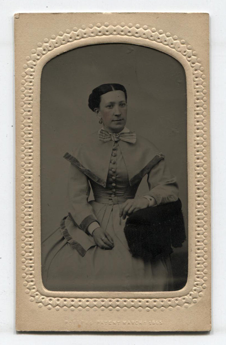 TINTYPE, WOMAN IN SHOULDER CAPE, TINTED. PERIOD MAT WITH MAKER MARK.