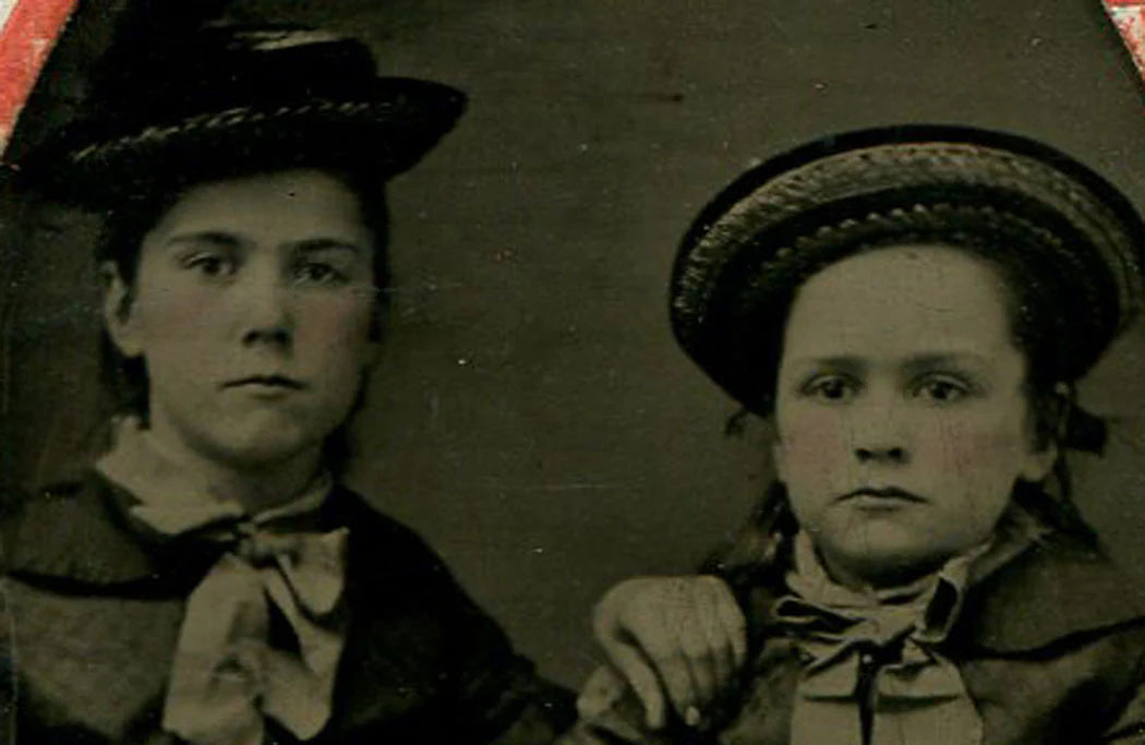 TWO YOUNG GIRLS LOOKING VERY GROWN UP. COOL HATS, BOTH. TINTED TINTYPE.