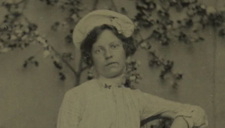LADY W/ HAT SITTING IN CHAIR, 1/6 PLATE TINTYPE PORTRAIT