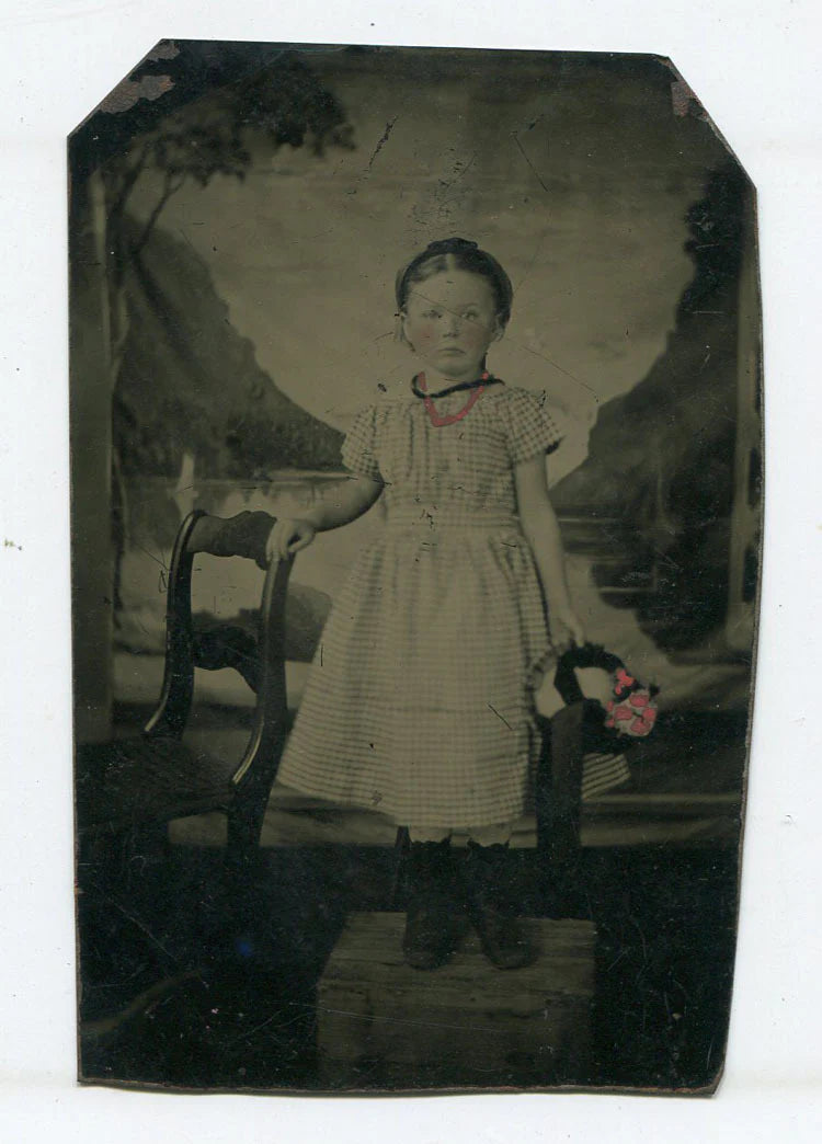YOUNG GIRL CHECKER DRESS, TINTED FLOWERS, NECKLACE. PAINTED BACKGROUND. TINTYPE.
